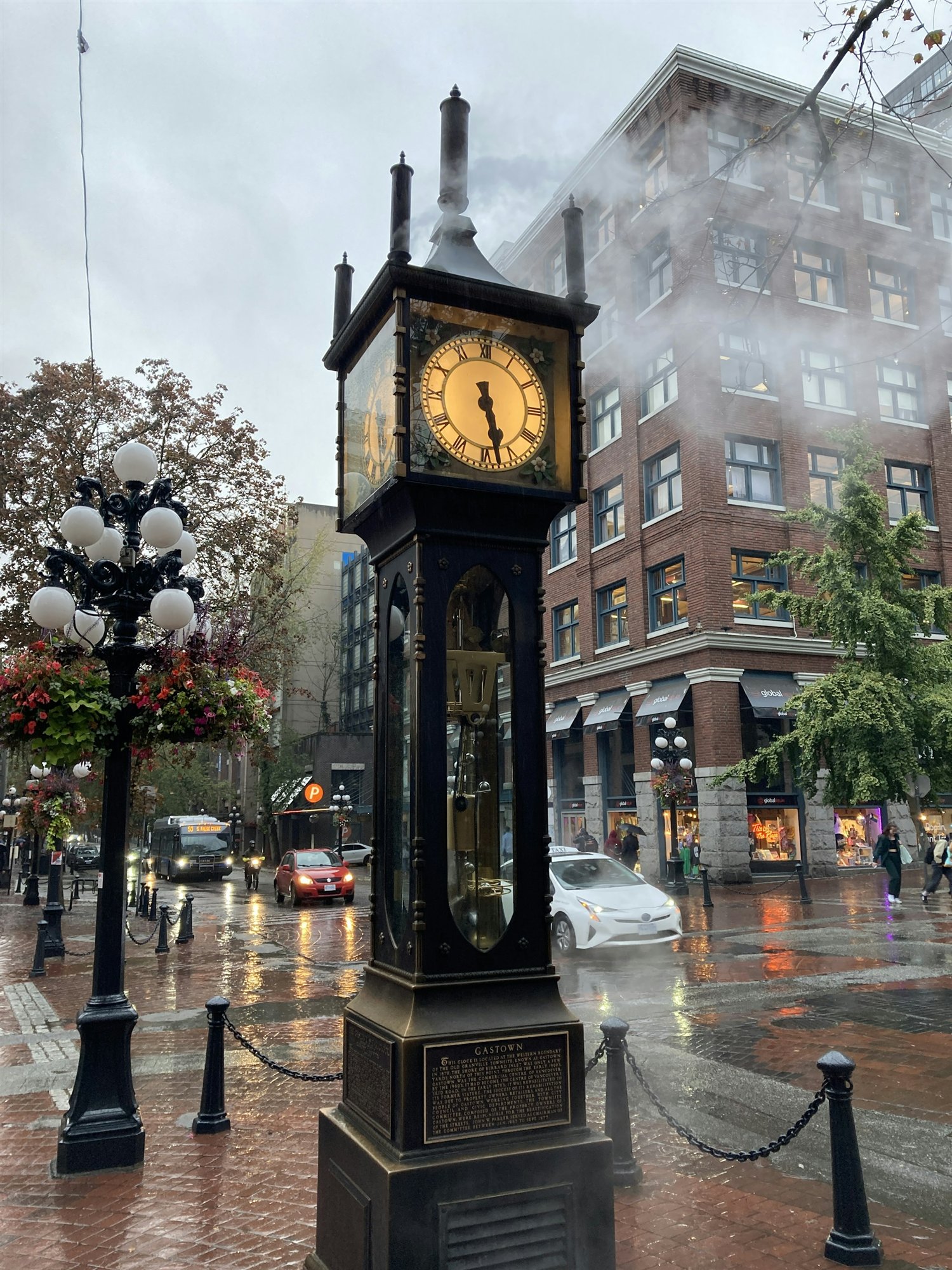 The Gastown steam clock glowing on a rainy Vancouver street